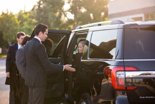 Chauffeur opening door for first-time black car service passenger in Scottsdale